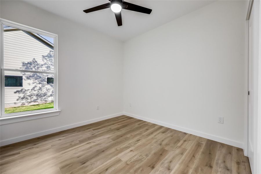 Spare room featuring a ceiling fan and light wood-style flooring Spare room featuring a ceiling fan and light wood-style flooring