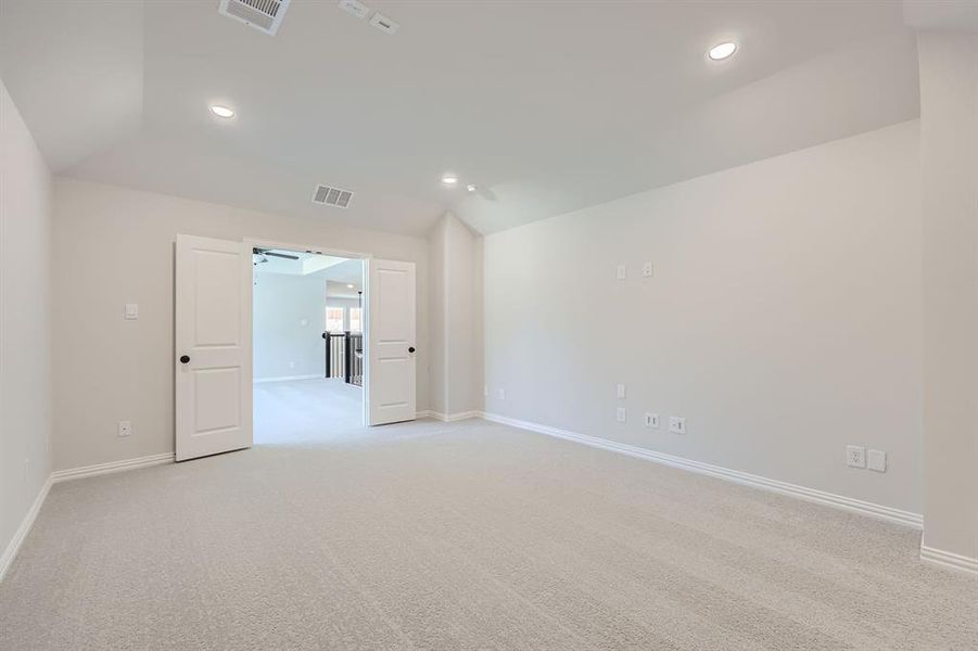 Unfurnished room featuring vaulted ceiling, light carpet, and ceiling fan