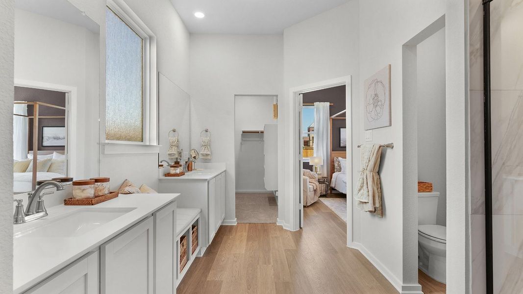 The bathroom features a dual vanity with ample storage and a private water closet, leading to a spacious primary suite. The bathroom features a dual vanity with ample storage and a private water closet, leading to a spacious primary suite.