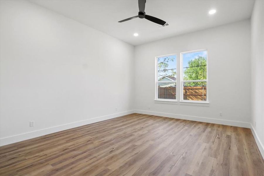 Spare room featuring light wood-type flooring, recessed lighting, and a ceiling fan