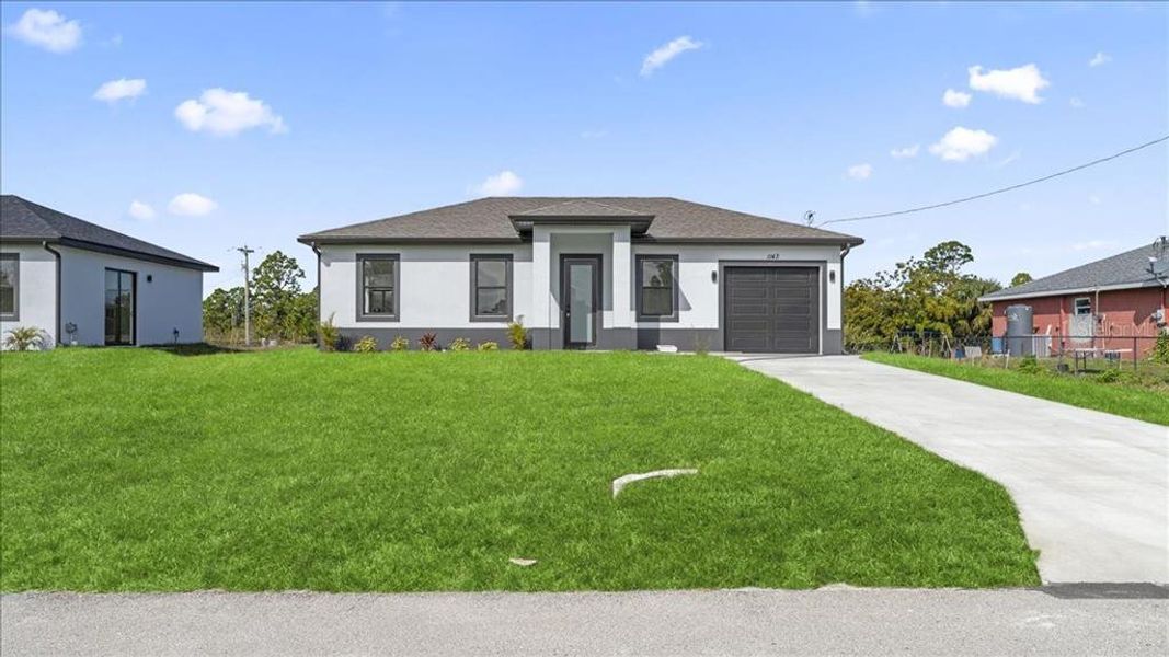 Front exterior of a new home in , Lehigh Acres, FL, highlighting curb appeal (Image 17).