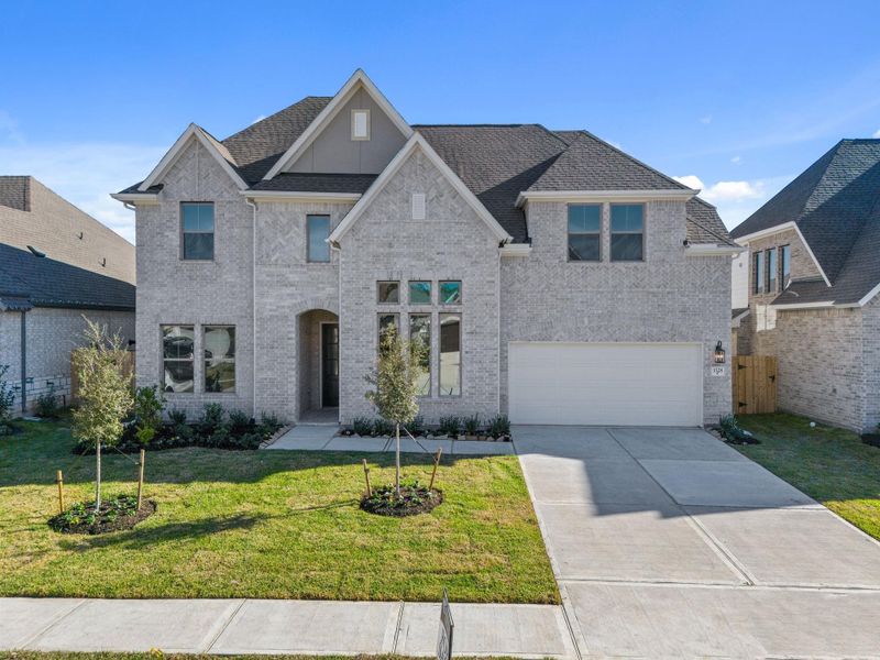 Front exterior of a new home in The Meadows at Imperial Oaks 60', Conroe, TX, highlighting curb appeal (Image 21).