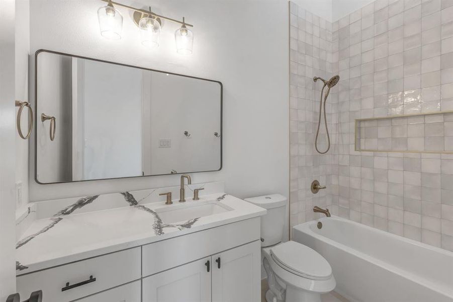 Bathroom featuring  shower combination and vanity