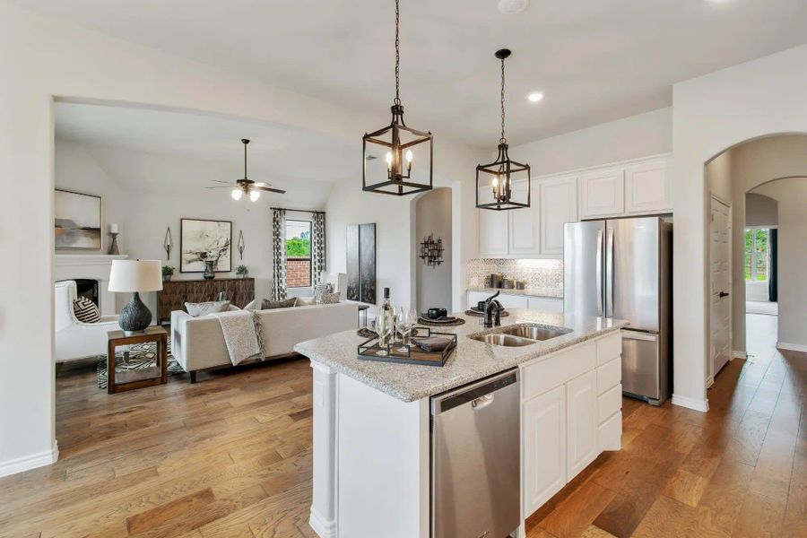 Kitchen to Family Room | Concept 2434 at Coyote Crossing in Godley, TX by Landsea Homes