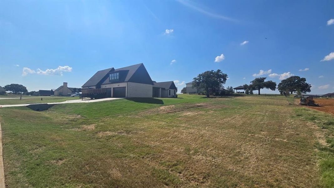 View of green lawn featuring a garage