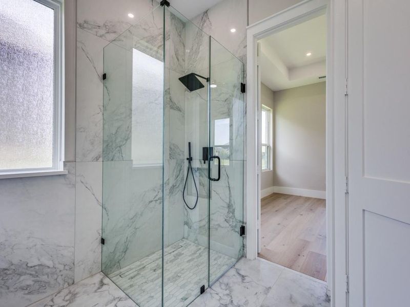 Primary bath, with marble finish shower, marble flooring