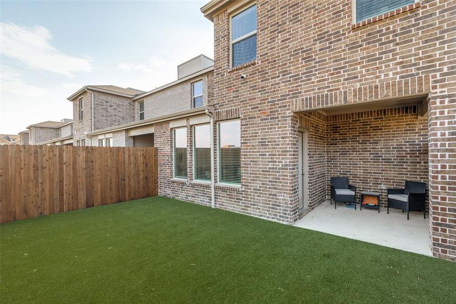Back of property featuring brick siding and a patio area Back of property featuring brick siding and a patio area