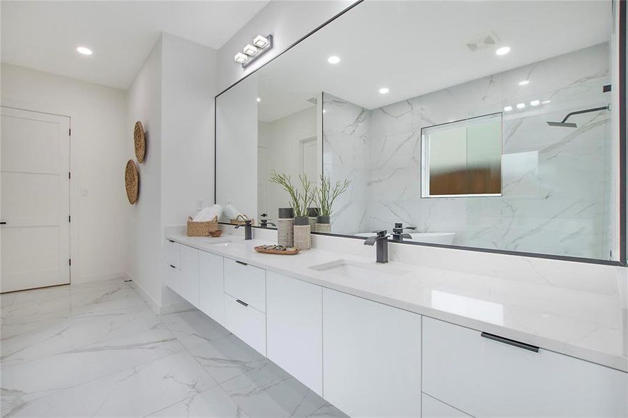 Bathroom featuring vanity and a tile shower