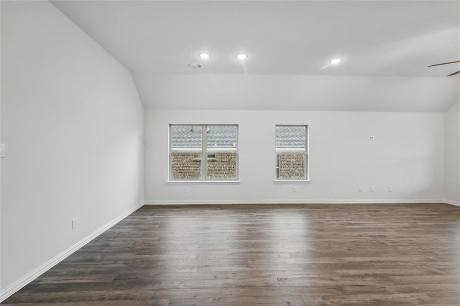 Spare room featuring dark wood-style flooring, a ceiling fan, recessed lighting, and lofted ceiling Spare room featuring dark wood-style flooring, a ceiling fan, recessed lighting, and lofted ceiling