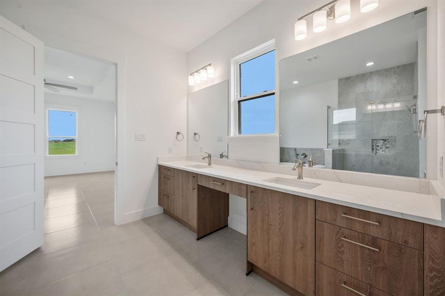 Master bath featuring a sink, a stall shower, double vanity, and a healthy amount of sunlight Master bath featuring a sink, a stall shower, double vanity, and a healthy amount of sunlight