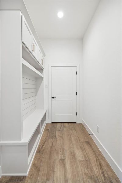 Mudroom with light hardwood / wood-style flooring