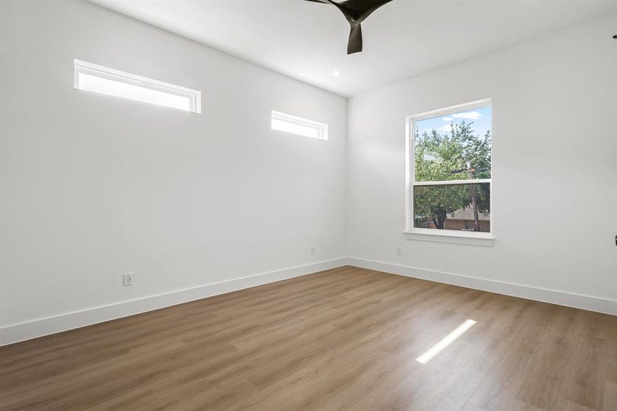 Empty room with light hardwood / wood-style flooring