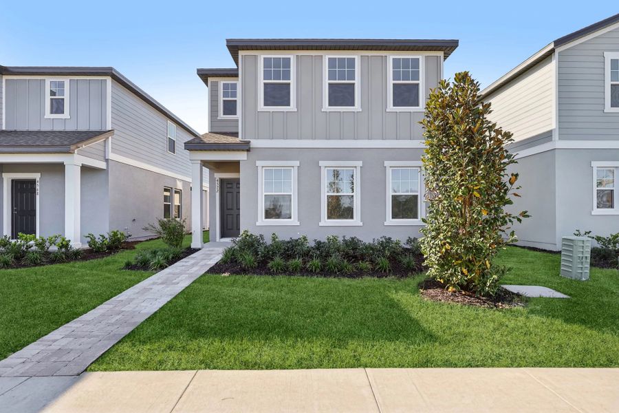 Front exterior of a new home in Hawks Run, Kissimmee, FL, highlighting curb appeal (Image 1). Front exterior of a new home in Hawks Run, Kissimmee, FL, highlighting curb appeal (Image 1).