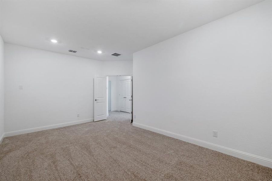 Unfurnished room with baseboards, recessed lighting, visible vents, and light colored carpet