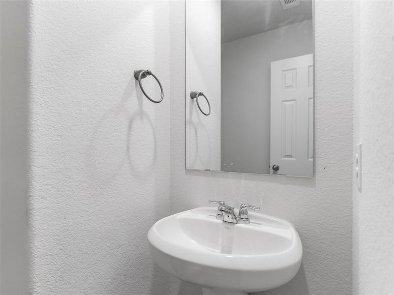 Convenient downstairs half bath for guests. Convenient downstairs half bath for guests.