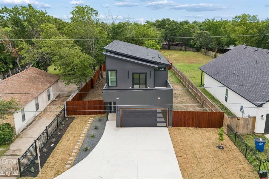Modern two-story residence featuring a dark gray facade and a sloped roofline Modern two-story residence featuring a dark gray facade and a sloped roofline
