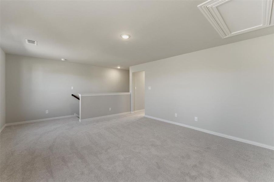 Unfurnished room with baseboards and light colored carpet