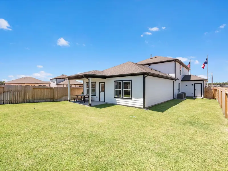 A house with a fence and grass. A house with a fence and grass.