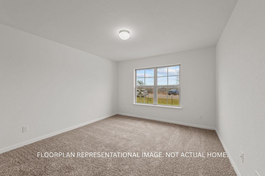 A well-lit bedroom provides a canvas for personalization, complete with soft carpeting and ample window views.