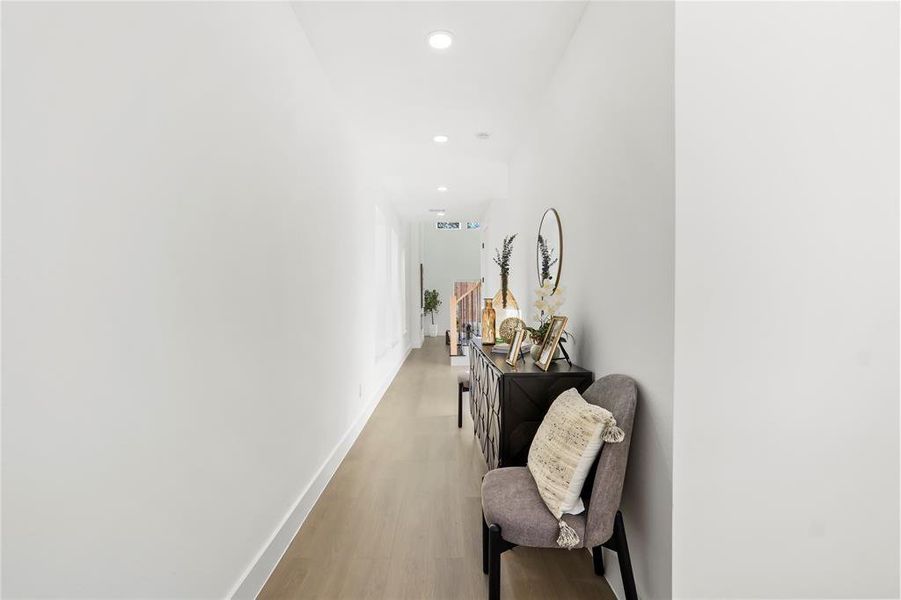Hall featuring wood finished floors and recessed lighting