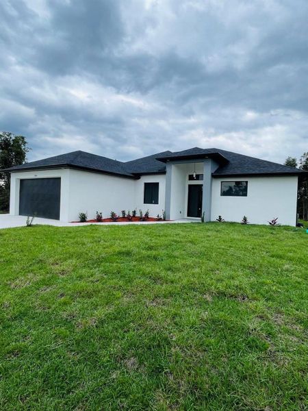 Front exterior of a new home in , Lehigh Acres, FL, highlighting curb appeal (Image 1). Front exterior of a new home in , Lehigh Acres, FL, highlighting curb appeal (Image 1).