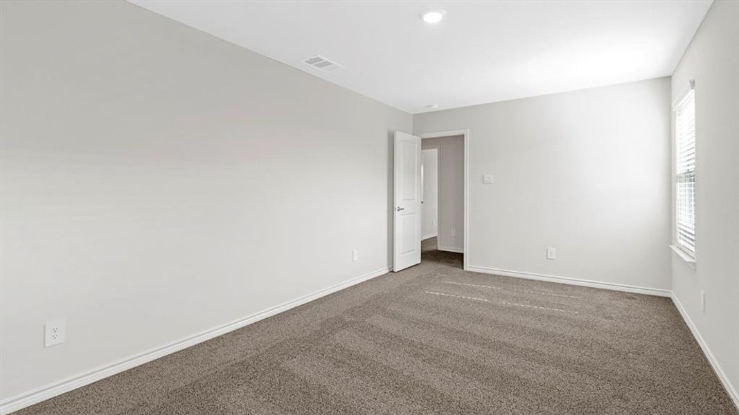 This room features light-colored walls and grey carpet flooring This room features light-colored walls and grey carpet flooring