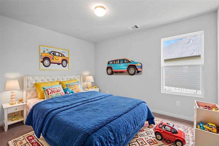 This secondary bedroom features custom paint, plush carpet, and a large window with privacy blinds!