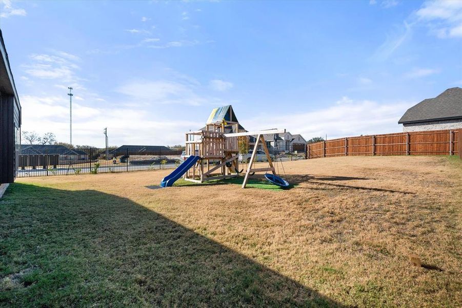 Community playground with a fenced backyard