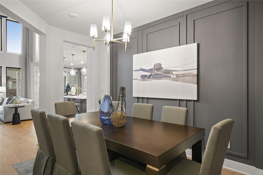 Dining area with light wood-style floors and a chandelier