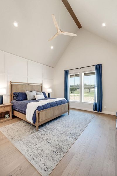 Bedroom with recessed lighting, light wood-style flooring, ceiling fan, and a decorative wall