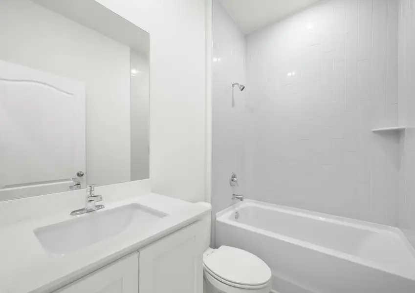Secondary bathroom in the Braden - FL home in Fort Pierce with a tub/shower combo and cultured marble vanity.