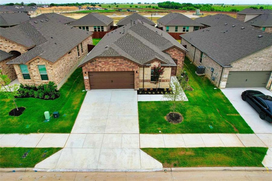 Front exterior of a new home in , Haslet, TX, highlighting curb appeal (Image 18). Front exterior of a new home in , Haslet, TX, highlighting curb appeal (Image 18).