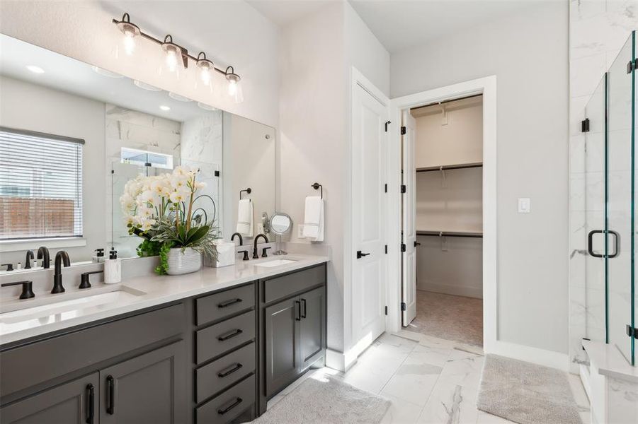 Bathroom featuring vanity and an enclosed shower