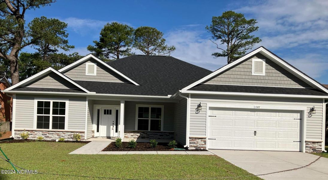 Front exterior of a new home in Summer Place, Grimesland, NC, highlighting curb appeal (Image 1).