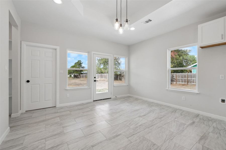 Spare room with plenty of natural light, recessed lighting, baseboards, and a chandelier Spare room with plenty of natural light, recessed lighting, baseboards, and a chandelier