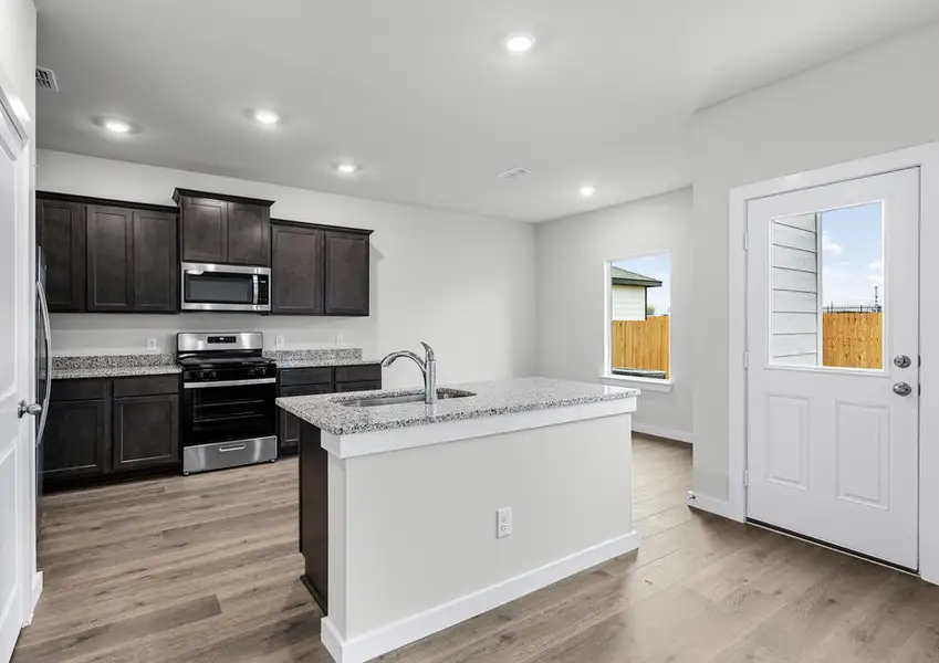 The kitchen has a convenient kitchen island. The kitchen has a convenient kitchen island.