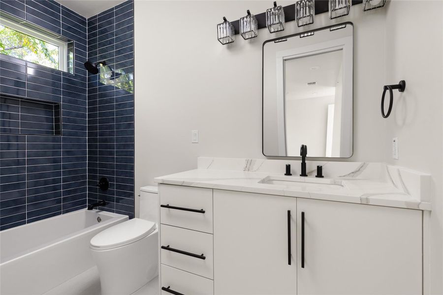 Clean lines and modern tile work define this contemporary bathroom space.