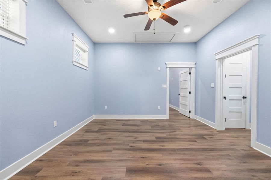 Peaceful bedroom retreat within the private living quarters featuring elevated ceilings, soft natural light, and spacious accommodations.