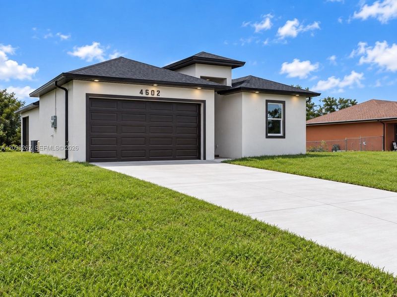 Front exterior of a new home in , Lehigh Acres, FL, highlighting curb appeal (Image 17).