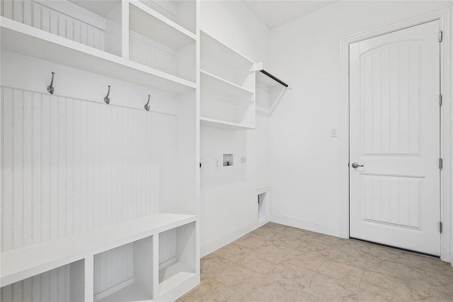 Mudroom with light tile patterned floors