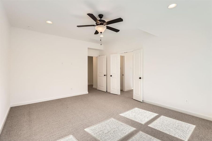 Unfurnished bedroom with carpet flooring and ceiling fan