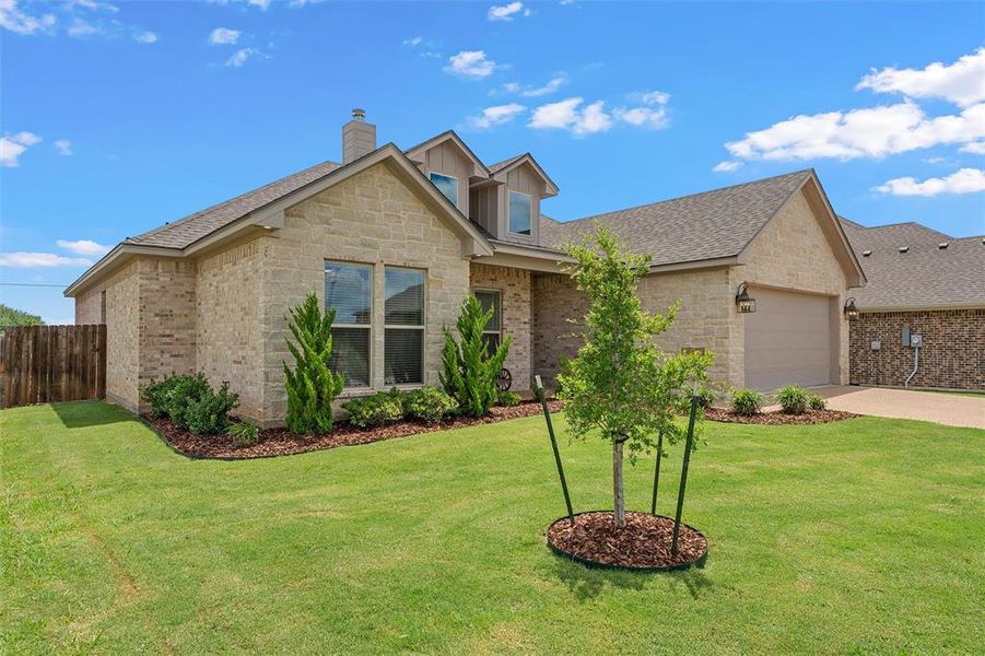 Stone facade with architectural shingle roof and covered front porch. Stone facade with architectural shingle roof and covered front porch.