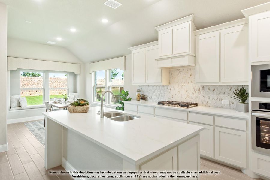 Kitchen with white cabinets, large center island with sink, tile backsplash, and built-in appliances Kitchen with white cabinets, large center island with sink, tile backsplash, and built-in appliances