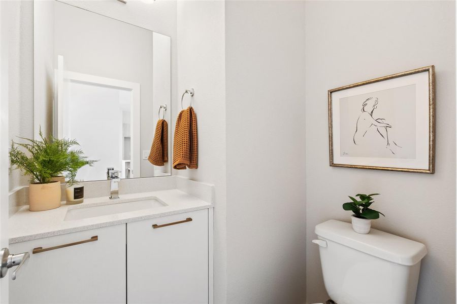 A thoughtfully placed powder bath, tucked away for guests with clean lines, modern finishes, and just the right amount of polish.