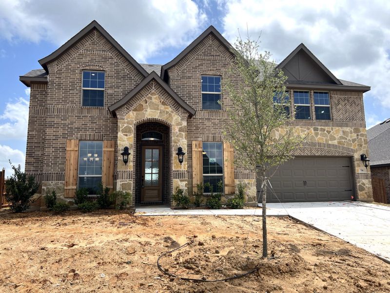 Front exterior of a new home in Mockingbird Hills, Joshua, TX, highlighting curb appeal (Image 1).