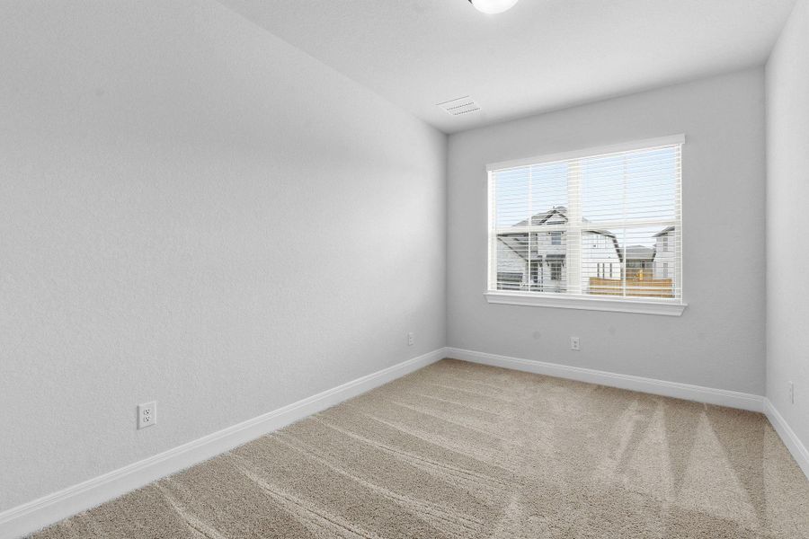 Spare room with light colored carpet and baseboards