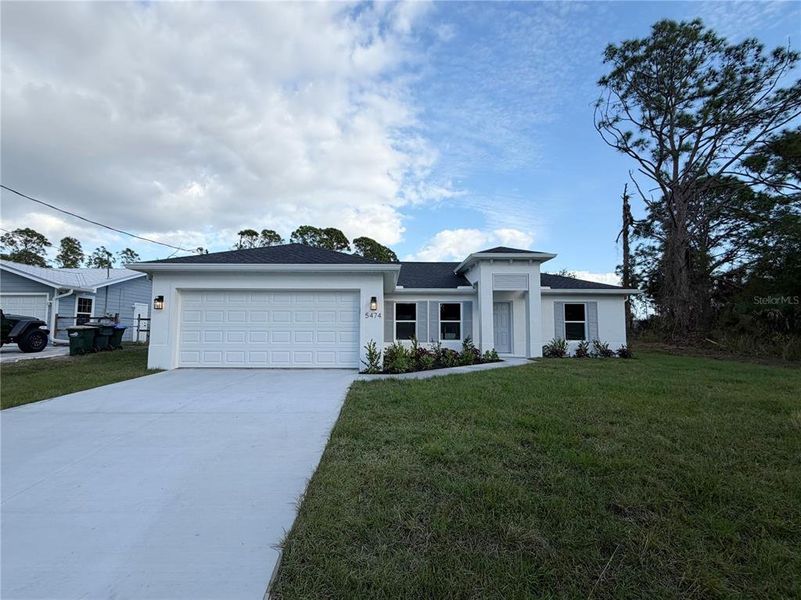 Front exterior of a new home in , North Port, FL, highlighting curb appeal (Image 1). Front exterior of a new home in , North Port, FL, highlighting curb appeal (Image 1).