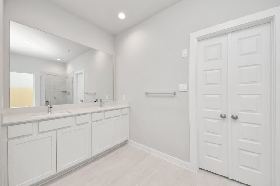 Escape to a spa-like oasis in this primary bathroom. Enjoy a walk-in shower with tile surround, a separate garden tub with custom detailing, and an elegant vanity featuring light countertops, modern hardware, and beautiful recessed lights. Experience luxury and relaxation in every detail. Sample photo of completed home with similar floor plan. Actual colors and selections may vary. Escape to a spa-like oasis in this primary bathroom. Enjoy a walk-in shower with tile surround, a separate garden tub with custom detailing, and an elegant vanity featuring light countertops, modern hardware, and beautiful recessed lights. Experience luxury and relaxation in every detail. Sample photo of completed home with similar floor plan. Actual colors and selections may vary.