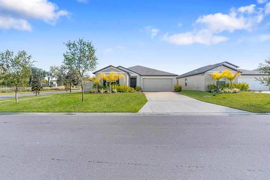 Front exterior of a new home in North Park Isle: The Estates II, Plant City, FL, highlighting curb appeal (Image 25). Front exterior of a new home in North Park Isle: The Estates II, Plant City, FL, highlighting curb appeal (Image 25).