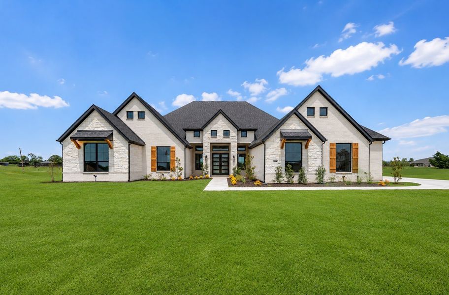 Front exterior of a new home in Heritage, McLendon-Chisholm, TX, highlighting curb appeal (Image 1). Front exterior of a new home in Heritage, McLendon-Chisholm, TX, highlighting curb appeal (Image 1).